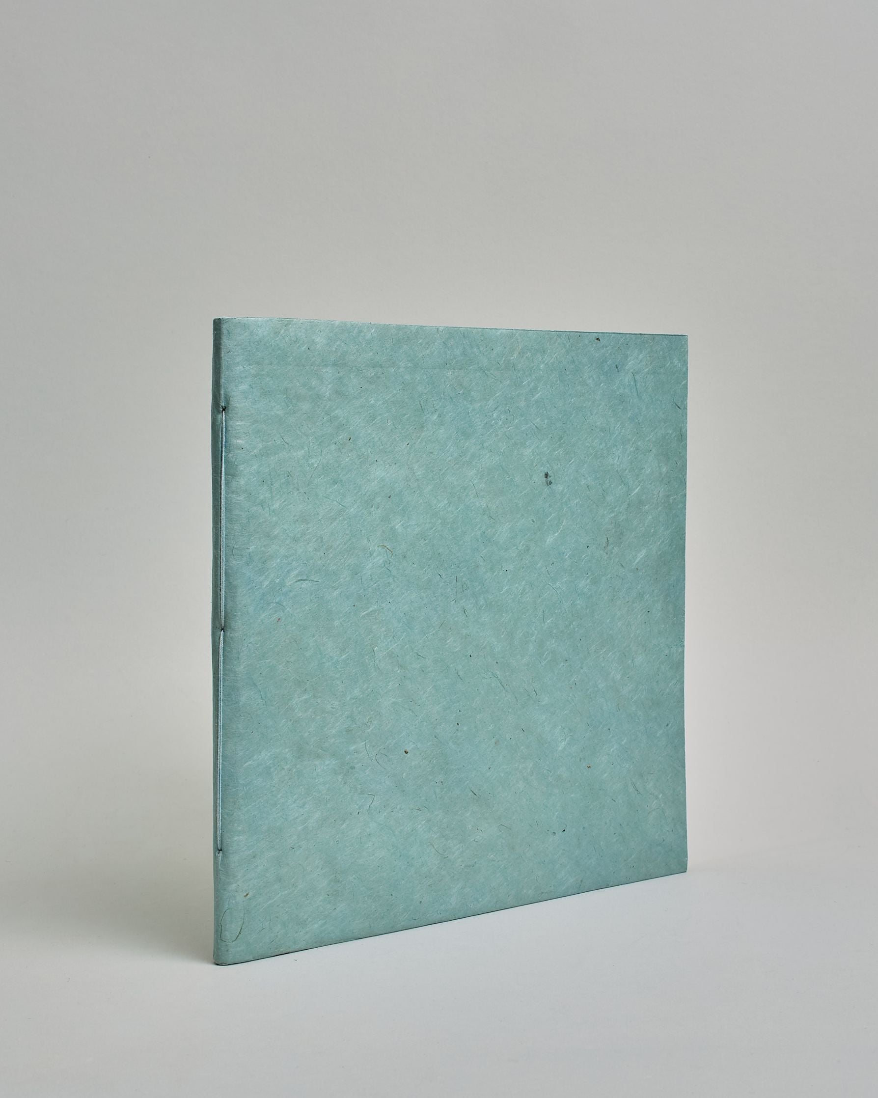 Ein Quadratisches Fotoalbum oder Gästebuch mit Softcover einfärbig in hellblau.