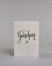 Gutschein-Karte mit der Aufschrift „Gutschein für …“ in schwarzer Handlettering-Schrift. Darunter befinden sich gepunktete Linien zum individuellen Ausfüllen auf hellem Hintergrund. Dazu ein grün-goldenes handgeschöpftes Kuvert. #1