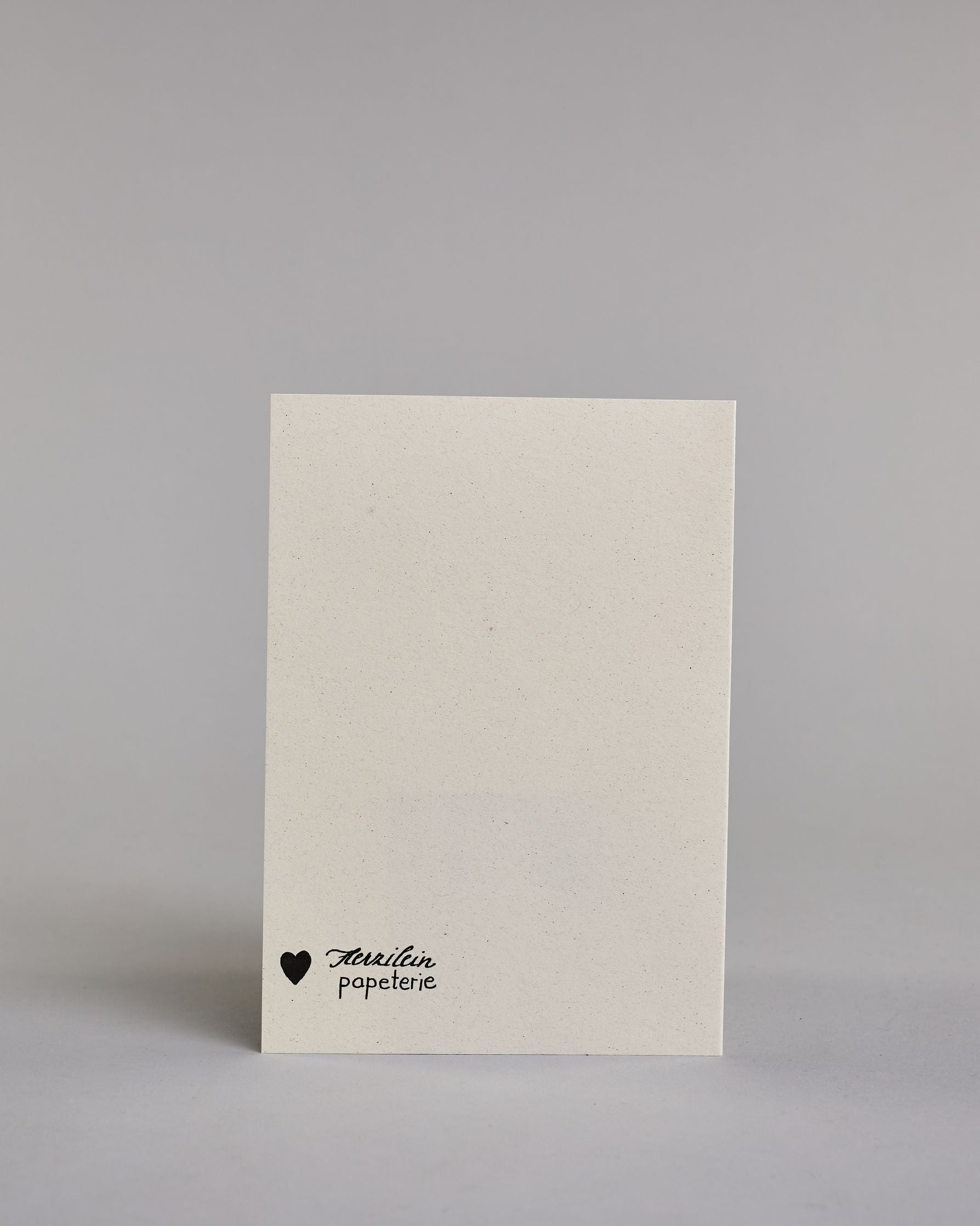 Glückwunschkarte in Englisch zum Geburtstag mit schwarzer Kalligrafieaufschrift "Happy Birthday to you". Der Text ist in drei Zeilen aufgeteilt, welche wiefolge gegliedert sind: "HAPPY", darunter "Birthday", darunter "TO YOU". Die Worte sind mit schwungvollen Linien und Verzierungen umgeben und alles ist mit Gold akzentuiert. Alles ist auf hellem Hintergrund. Dazu ein grün-goldenes handgeschöpftes Kuvert. #4