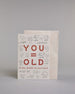 Glückwunschkarte auf Englisch zum Geburtstag mit roter Aufschrift "YOU=OLD if my math is correct", mit schwarzen mathematischen Zeichen Ziffern und Diagrammen rund um die mittig gesetzte Schrift auf hellem Hintergund. Aufgeteilt ist die Schrift wiefolgt: "YOU", darunter "=", darunter "OLD", darunter "if my math is correct". Dazu ein weißes handgeschöpftes Kuvert. #2