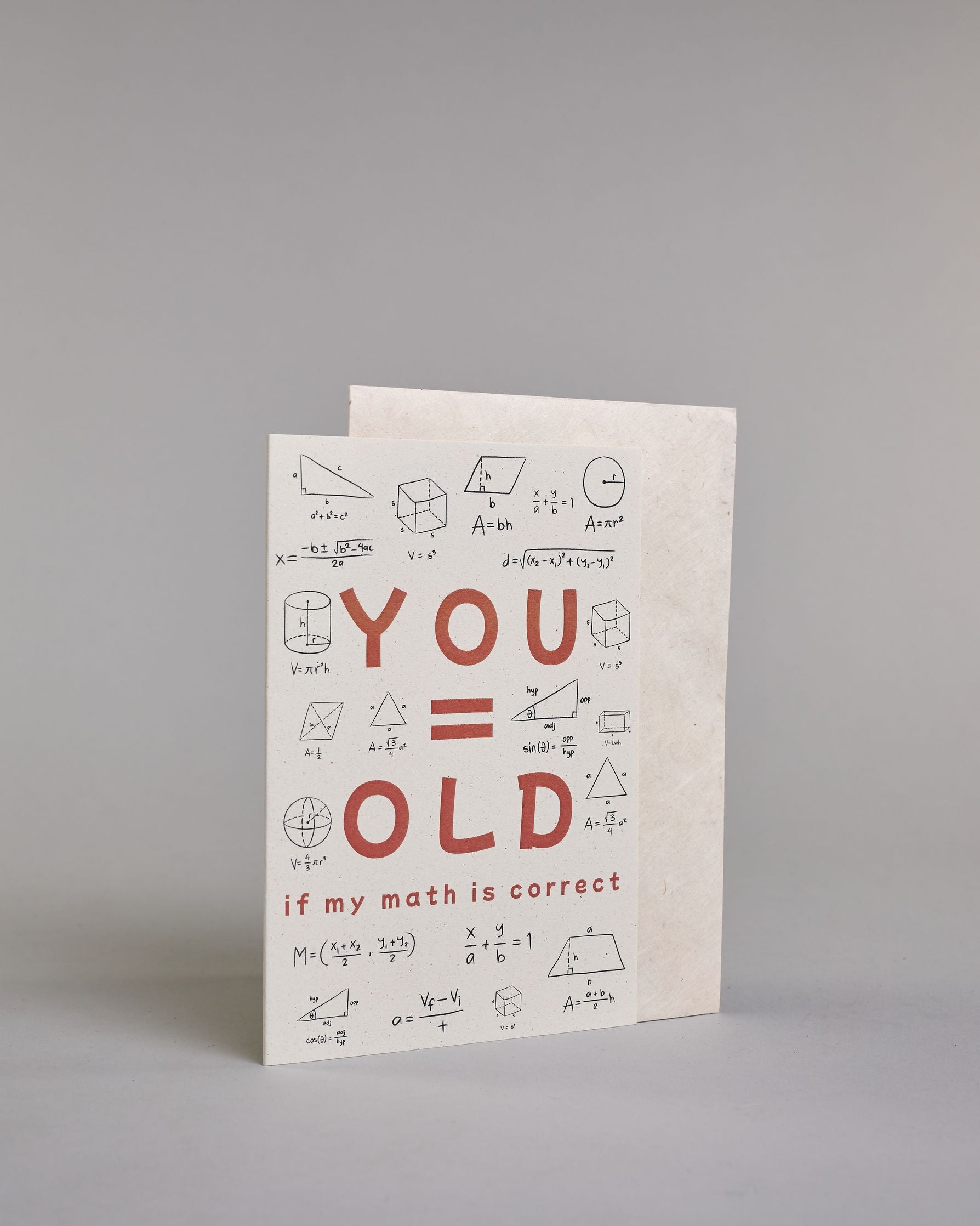 Glückwunschkarte auf Englisch zum Geburtstag mit roter Aufschrift "YOU=OLD if my math is correct", mit schwarzen mathematischen Zeichen Ziffern und Diagrammen rund um die mittig gesetzte Schrift auf hellem Hintergund. Aufgeteilt ist die Schrift wiefolgt: "YOU", darunter "=", darunter "OLD", darunter "if my math is correct". Dazu ein weißes handgeschöpftes Kuvert. #3