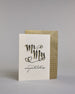 Glückwunschkarte zur Hochzeit in Enlisch mit der Kalligrafieaufschrift "MrMrs congratulations" In großer, geschwungener Schrift mit schwarzen Buchstaben und goldfarbenen Datails steht „Mr Mrs“. Um die Wörter herum sind drei kleine Herzen gezeichnet – eines links unten, eines rechts oben am „r“ und eines rechts unten beim „s“.
Darunter, in kleinerer, feiner Schreibschrift, steht das Wort „congratulations“ in Schwarz.  Dazu ein gold-weißes handgeschöpftes Kuvert. #3