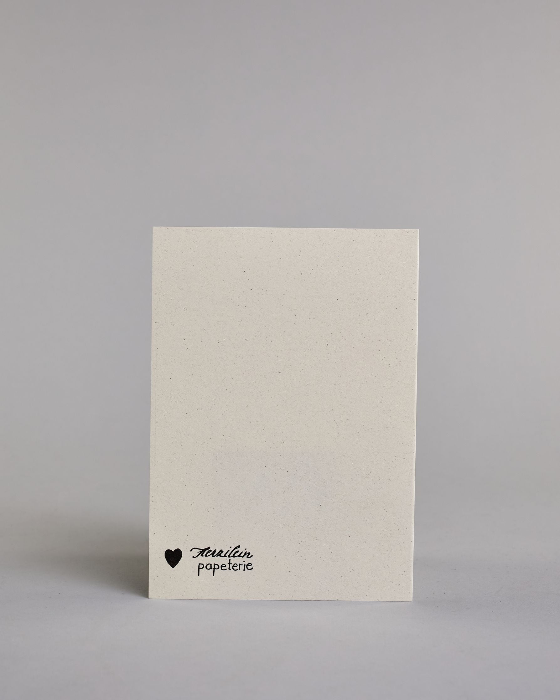 Glückwunschkarte zur Hochzeit für zwei Frauen mit der Kalligrafieaufschrift "Mrs & Mrs herzlichen Glückwunsch" auf hellem Hintergrund. Sie zeigt oben zwei schwarze Schachfiguren in Form von Bauern, die mit feinen goldenen Linien akzentuiert sind. Darunter steht in großer, geschwungener schwarzer Schrift mit goldenen Details „Mrs & Mrs“. Unterhalb davon befindet sich in geschwungener schwarzer Schreibschrift auf zwei Zeilen "herzlichen Glückwunsch" darunter ist ein kunstvoller goldener Schwung. Dazu ein gol…