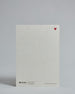 Die Rückseite der Postkarte im Hochformat vor hellgrauem Hintergrund. Rechts oben ist, in kleiner Ausführung, ein rotes Herz zu sehen. 
Unten sind klein das Logo Herzilein-Papeterie, der Text: "designed in VIenna, printed in Germany" und "www.herzilein-papeterie.at" zu sehen. 
Der Großteil ist unbedruckt die Struktur der hochwertigen Holzschliffpappe ist gut zu sehen. Hier ist viel Platz zum Schreiben.