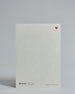 Die Rückseite der Postkarte im Hochformat vor hellgrauem Hintergrund. Rechts oben ist, in kleiner Ausführung, ein rotes Herz zu sehen. 
Unten sind klein das Logo Herzilein-Papeterie, der Text: "designed in VIenna, printed in Germany" und "www.herzilein-papeterie.at" zu sehen. 
Der Großteil ist unbedruckt die Struktur der hochwertigen Holzschliffpappe ist gut zu sehen. Hier ist viel Platz zum Schreiben.