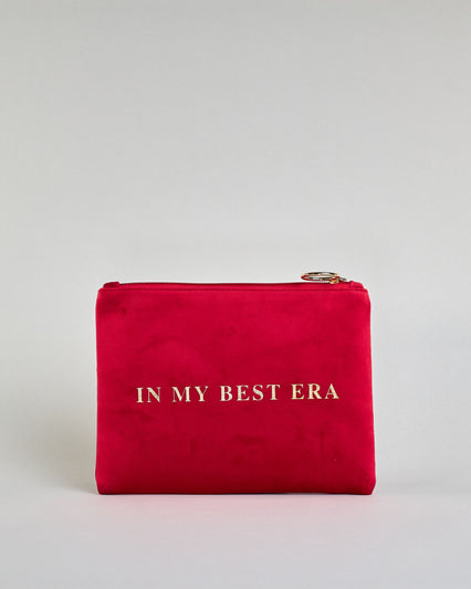Rote Kosmetiktasche aus Samtstoff mit großem goldenem Aufdruck "In my best era" in der Mitte. Zipp mit goldenem Metallring zum Verschließen. Futter aus Satinstoff in Kontrastfarbe. #1