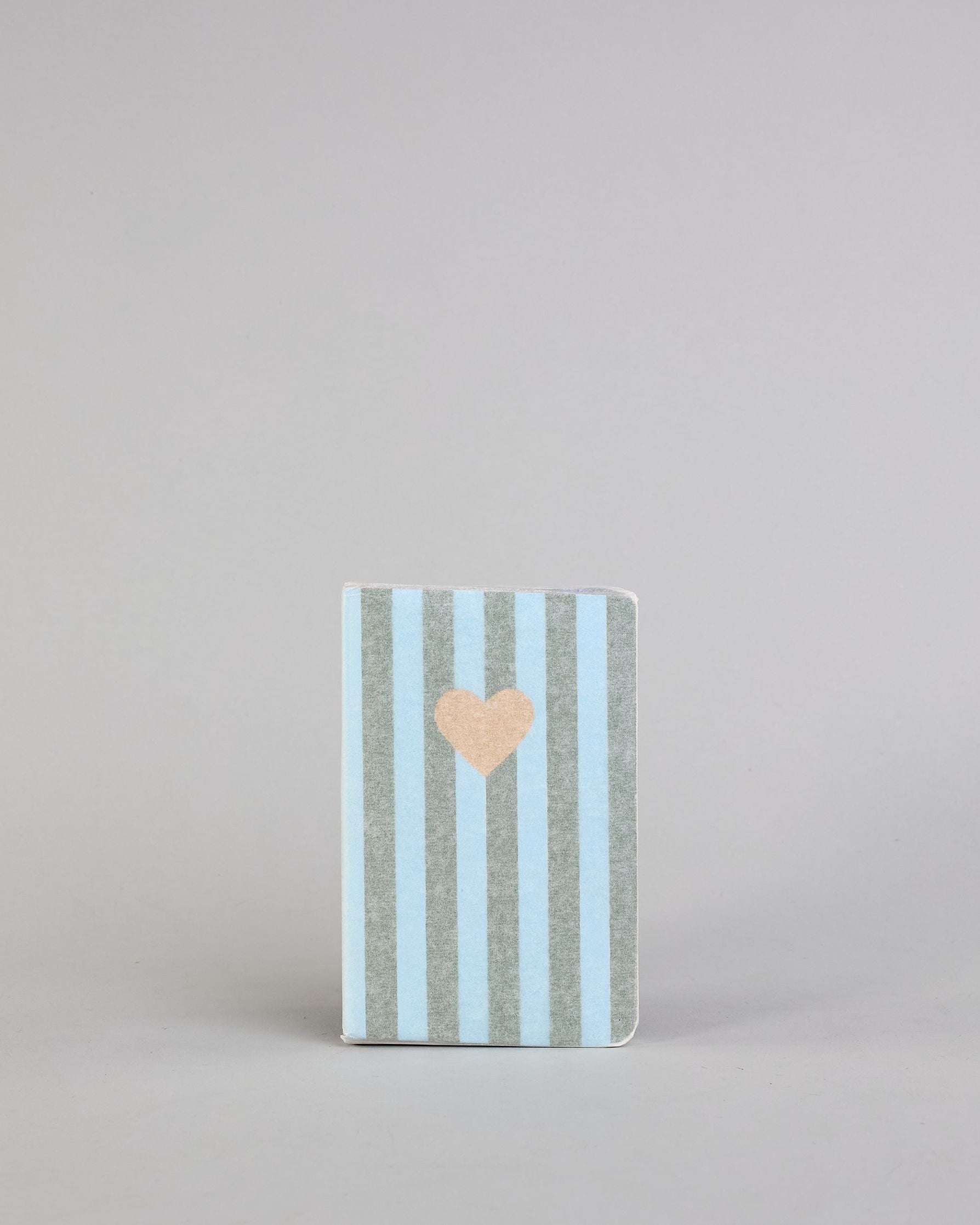 Set aus drei A6-Heften mit recyceltem Baumwolleinband. Die Hefte sind mit senkrechten Streifen in Blau- und Grüntönen gestaltet und zeigen auf dem Cover jeweils ein goldenes Motiv: ein Herz, ein Kleeblatt und eine Libelle. 30 glatte Seiten innen. #8