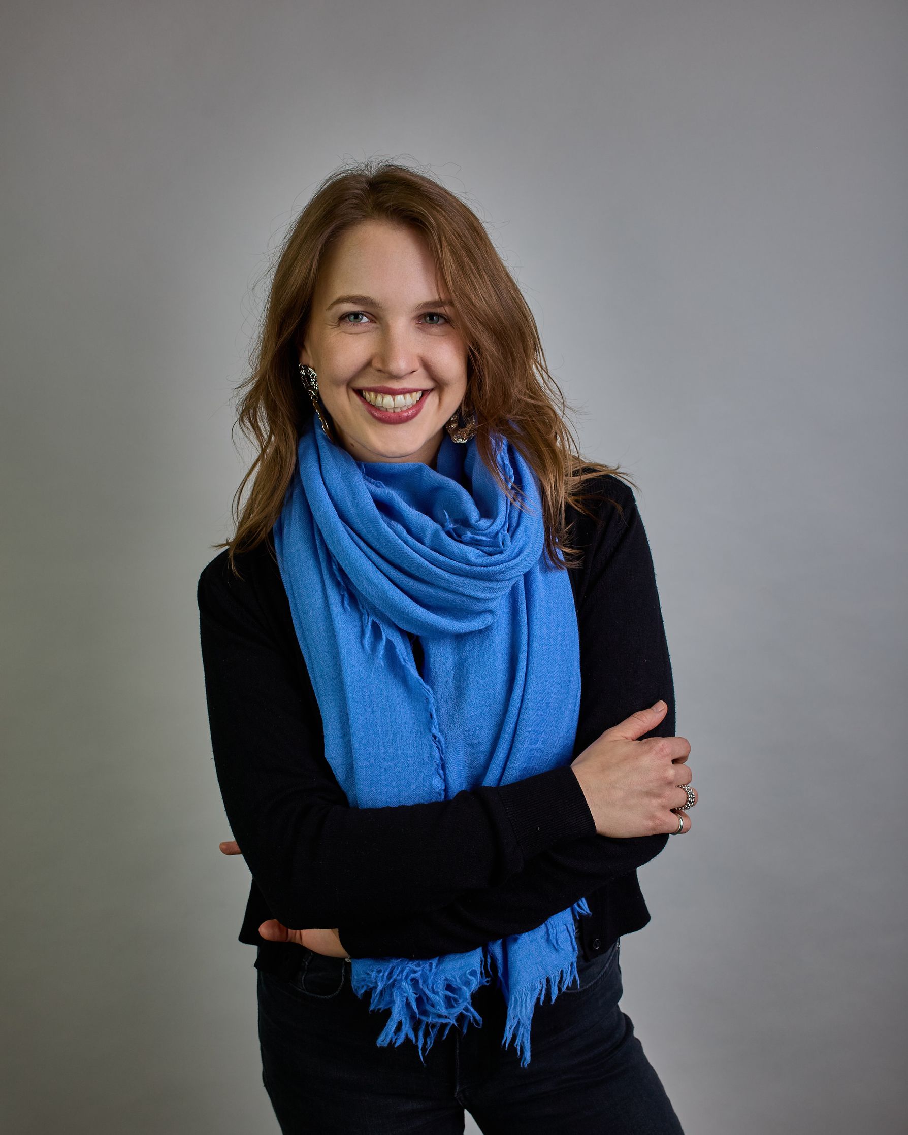 Ein Schal aus 100 % Wolle in einem kaltem Mittel Blauton mit den Maßen 100x180 cm. Je nach Bild ist er locker um den Hals gelegt oder einmal gewickelt, um eine Schlaufe um den Hals zu haben. Der Schal ist einfärbig und hat an den Kanten leichte Fransen. Die organische Struktur verleiht dem Schal ein lässiges, zeitloses Design. #5