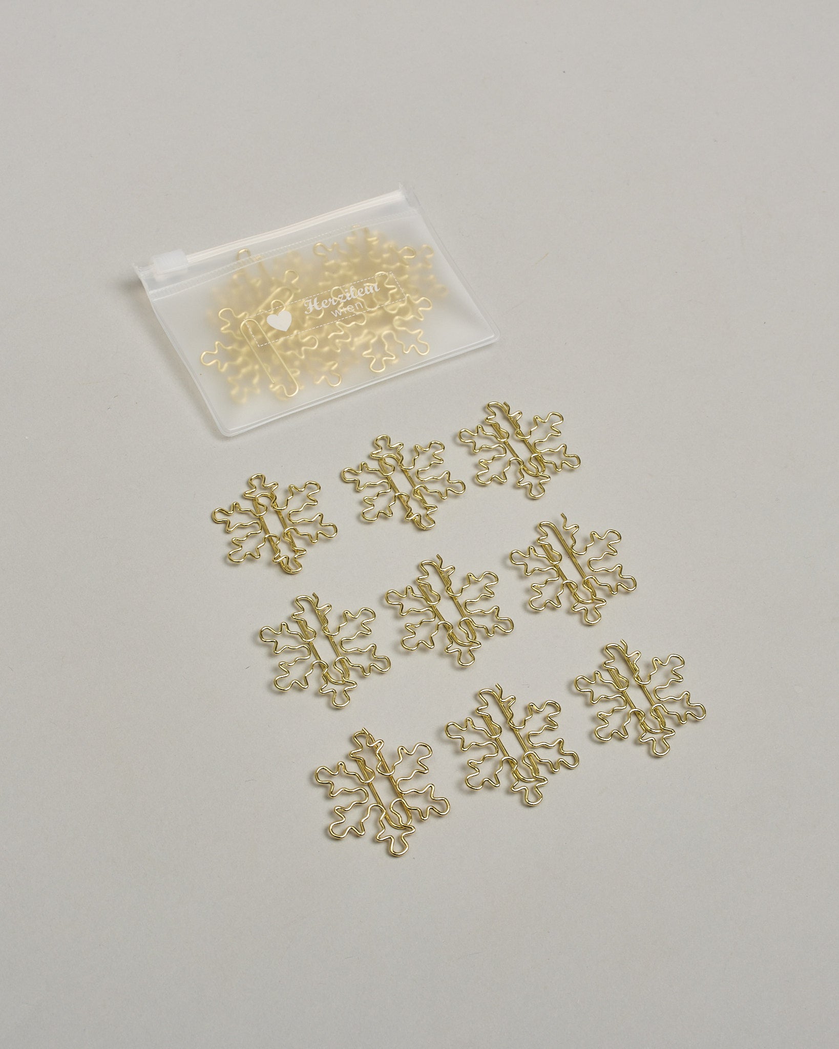 Büroklammern in Form von Schneeflocken aus goldenem Draht. Sie kommen in einer kleinen Silikonverpackung. #2